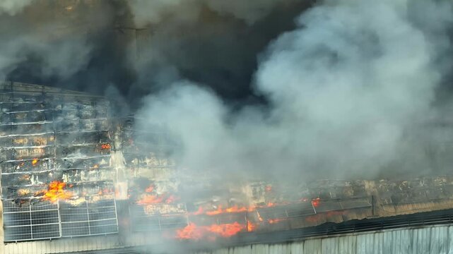 Aerial footage of a burning industrial facility with heavy smoke plumes, emphasizing climate crisis, rising emissions, net zero urgency, and the environmental cost of unsustainable operations. 4k.
