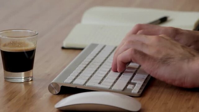 Online work and work from home on a laptop with  Keyboard along with Coffee and Notebook. Online learning and freelancing.  