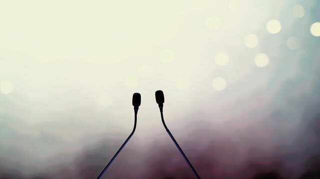 Dual Conference Microphones on Podium with Blurred Audience Background
