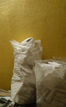 Post renovation cleanup with collected waste and construction materials packed in bags ready for disposal from interior work