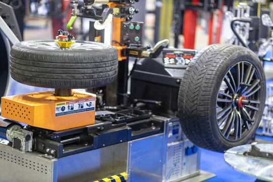 Automated tire replacement and wheel balancing machine in modern auto repair shop
