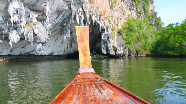 Scenic boat journey through a karst cave and emerald waters, promoting sustainable tourism, environmental protection, biodiversity preservation, and responsible travel experiences. Thailand. 4k.
