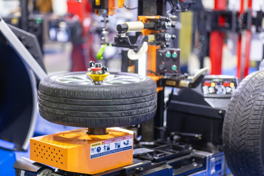Automated tire replacement and wheel balancing machine in modern auto repair shop
