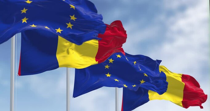 Romania and European Union flags waving in the wind on a clear day. Eu member since January 2007. Seamless 3d render animation. Slow motion loop. Selective focus