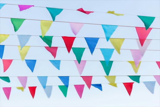 Festive colorful bunting flags hanging against a clear sky