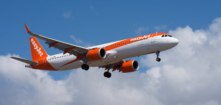Tenerife, Spain April 27st, 2026. Airbus A321-251NX easyJet Airlines flies in the blue sky with clouds. Landing at Tenerife Airport