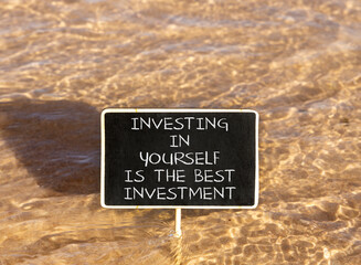 Naklejka premium Investing in yourself symbol. Concept words Investing in yourself is the best investment on beautiful blackboard. Beautiful sea water background. Business investing in yourself concept. Copy space