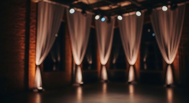 Elegant event space with draped curtains and dramatic uplighting, creating a sophisticated ambiance.