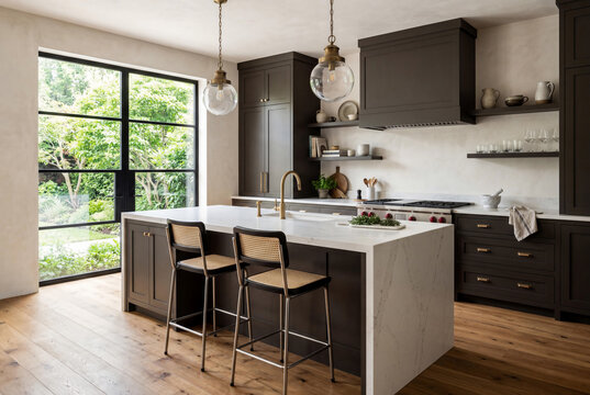 Sophisticated Kitchen Design Featuring Urbane Bronze Cabinets White Marble Waterfall Island and Brass Accents with Garden View