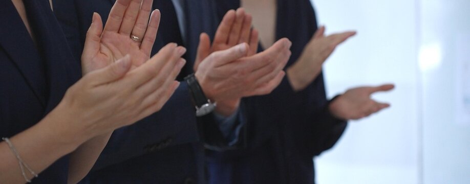 Business audience hands clapping, showing appreciation and success in a corporate meeting, celebrating achievement and positive feedback at a professional event