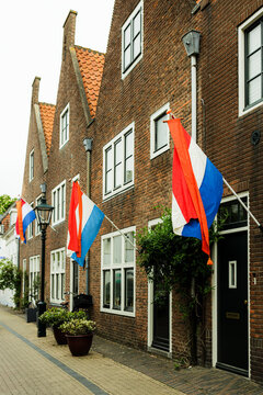 Row of Dutch brick houses with national flags on King's Day