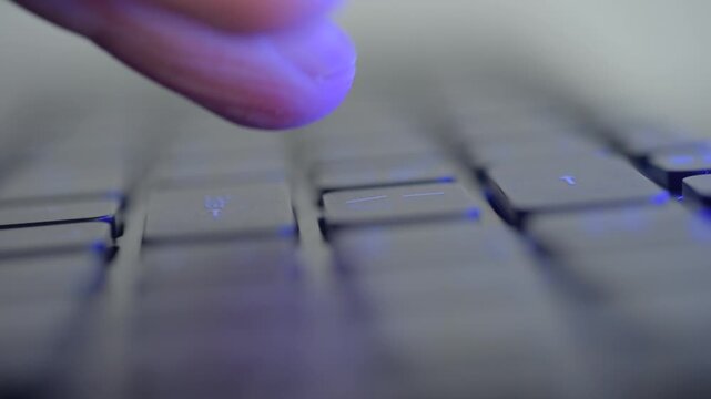 Closeup keyboard enter key press showing anxious fingertip hesitation, developer hesitates before committing code or message, soft RGB backlight, shallow depth of field, tense