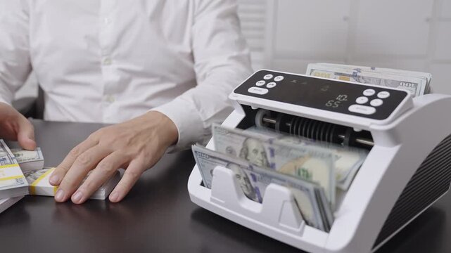 Hand counting dollars. Businessman hold money in hand. Business finance management in office. Banker counting cash closeup. Financial planning. Dollar counting machine concept.