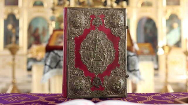 Ornamental biblical text book resting on altar with golden icon backdrop