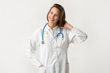 Fototapeta premium Beautiful female doctor with stethoscope on white background