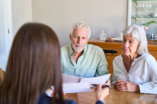 Retirement Planning And Financial Protection: Senior Couple Receiving Professional Advice On Estate And Inheritance Documents