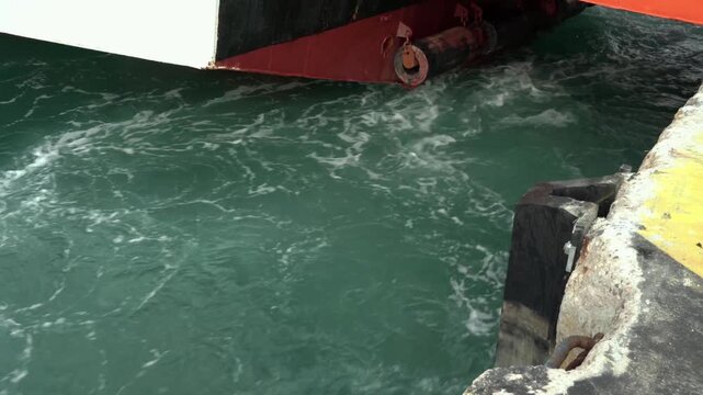 Ship's propeller water swirling from back side slow motion 