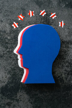 Stylized silhouette of a human head in profile, made in the colors of the American flag on a concrete background. Creative concept of American patriotism, July 4th celebration. Independence day.