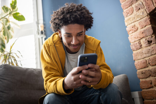 Teen boy connecting with friends on social media