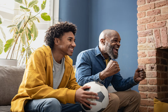 Father and son celebrate a soccer goal together