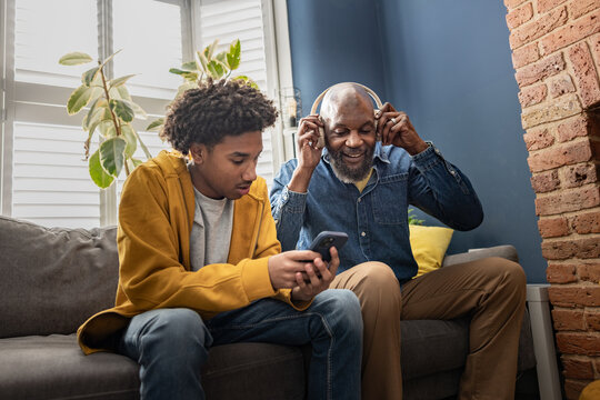Father and son listening to music together