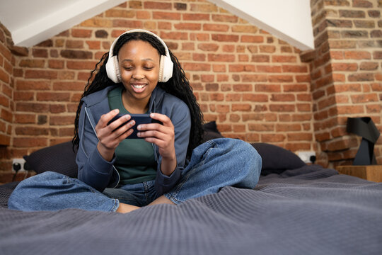 Teenage girl having fun with mobile gaming experience