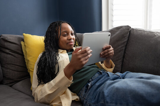 Teen Girl relaxing while browsing on her tablet