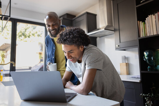Father and son enjoying time together on laptop