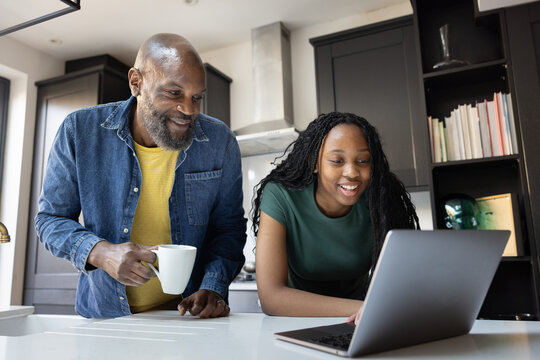 Father and daughter bonding over a laptop session