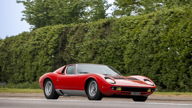 Bicester,Oxon.,UK - Apr 26th 2026:  1968 red Lamborghini Miura car driving on a British road