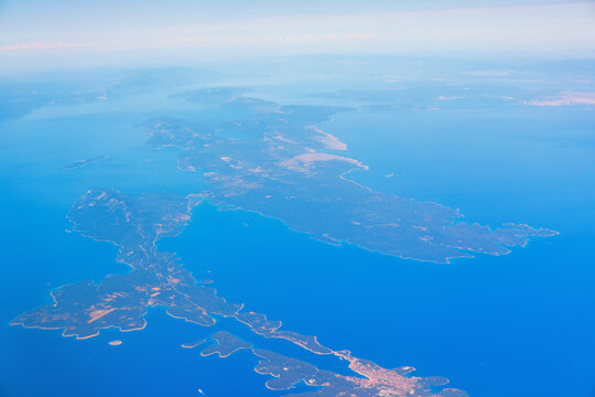 Pasman and Ugljan islands in Dalmatia near Zadar in aerial view as long, narrow chain linked by a bridge over Pasman Channel. Blue water, coastal villages and green hills form a calm Adriatic scene