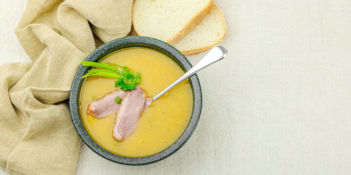 Rustic vegetable lentil soup with smoked duck breast served in a ceramic bowl. Creamy texture