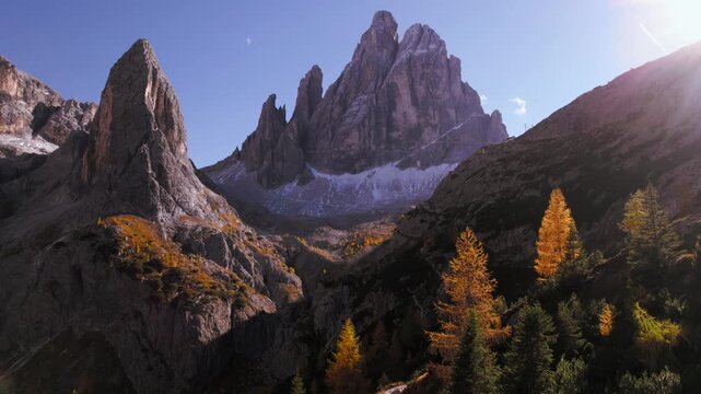 Mountain peak in Dolomites, Italy with golden larch trees on the foreground