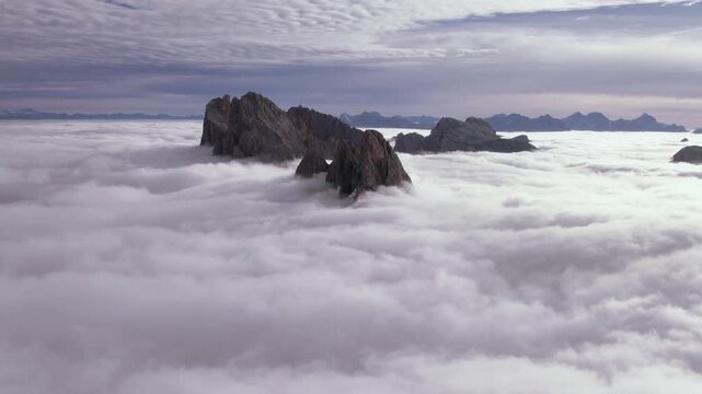 Flying above clouds at Seceda mountain, Dolomites, Italy