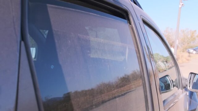 Car SUV side window opening and closing, close-up view of glass moving smoothly inside door frame, demonstrating vehicle mechanism, comfort control, interior detail and modern auto functionality