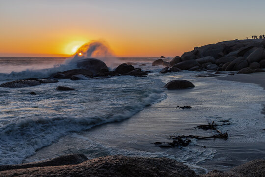 Sunset with splashing water at Maiden's Cove, a beautiful stretch of sandy beach between  Clifton and Glen Beach, with amazing views on the absolutely breath-taking Twelve Apostles Mountain Range The 