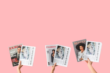 Women with newspapers and magazines on pink background