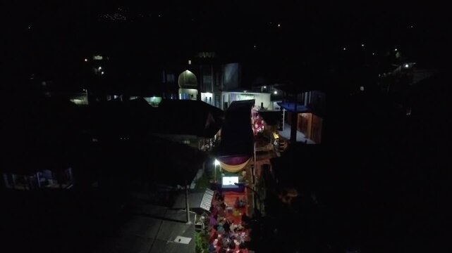 4K Aerial View of a Vibrant Indonesian Village Community Gathering at Night.