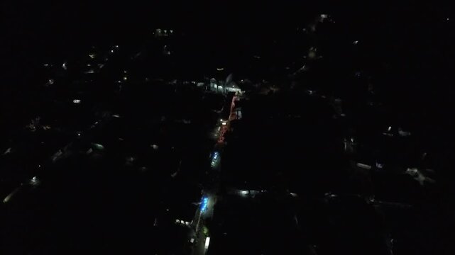 4K Aerial View of a Vibrant Indonesian Village Community Gathering at Night.