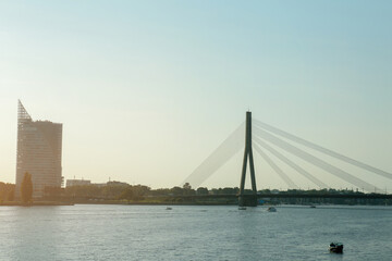 Obraz premium View of beautiful river with modern bridge and building in European city on sunny day