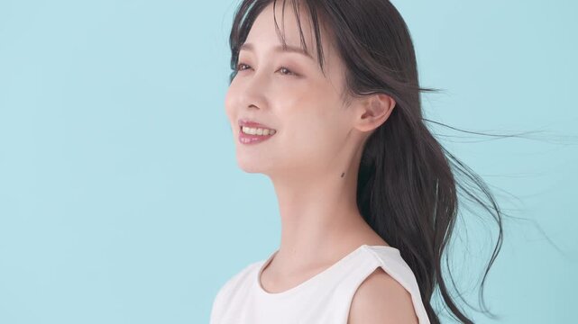 女性　ブルーバック　髪　風