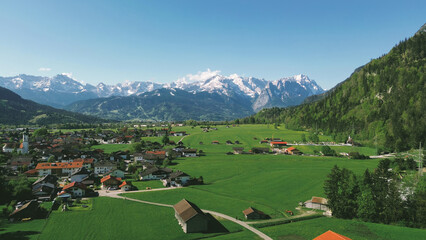 Naklejka premium Village landscape with dramatic mountains