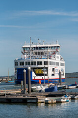 Fototapeta premium Lymington Hampshire England UK. 25.04.2026. Isle of Wight ferry White Sun negotiating the Lymington River with vehicles and passengers aboard inbound to the Lymington terminal.