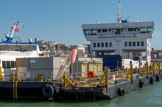 Portsmouth Harbour England UK. 26.04.2026. A large passenger and vehicle ferry named St Faith is moored on a floating dock midstream Portsmouth harbour with industrial structures