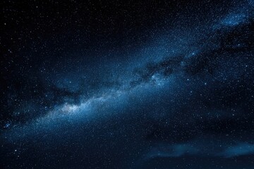 Fototapeta premium A breathtaking view of the Milky Way galaxy stretches across a dark, starry night sky, showcasing the vastness and beauty of the cosmos.