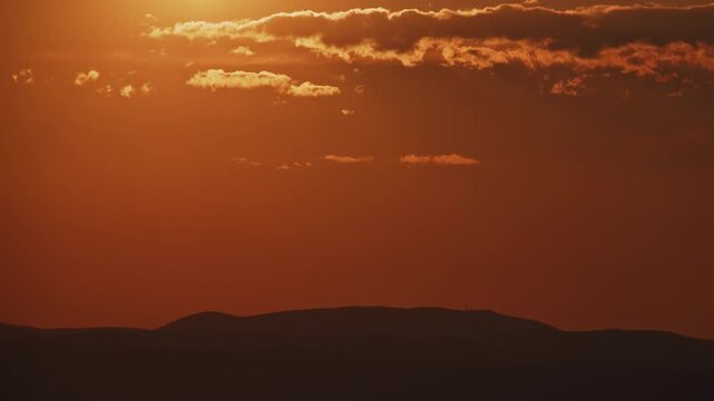 Dramatic Sunset Timelapse with Sun Over Mountain Silhouette Tight Shot