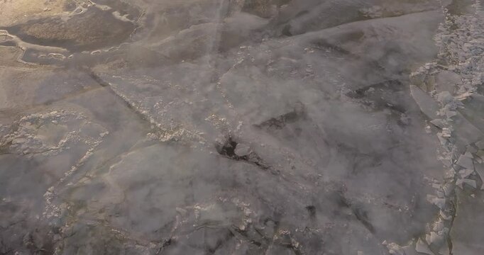 Large frozen river drone flight, lots of ice on the river at sunset