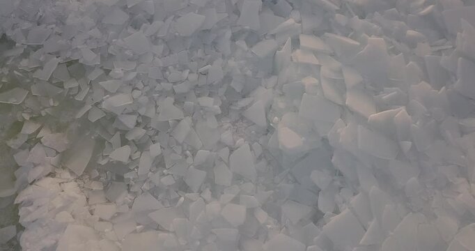 Large frozen river drone flight, lots of ice on the river at sunset in winter