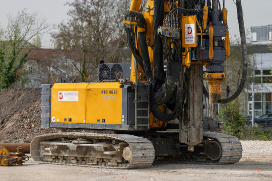 Nancy, France - April 13th 2022 : View on a yellow drilling rig Bauer RTG RG 22 S for special foundations on a construction site before the construction of a residential building.