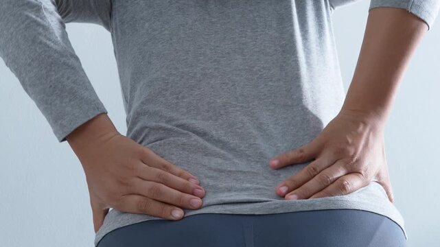 Woman suffering from waist, backache or hip pain. lower back while , chronic back pain, in office syndrome, scoliosis, herniated disc, muscle inflammation.	